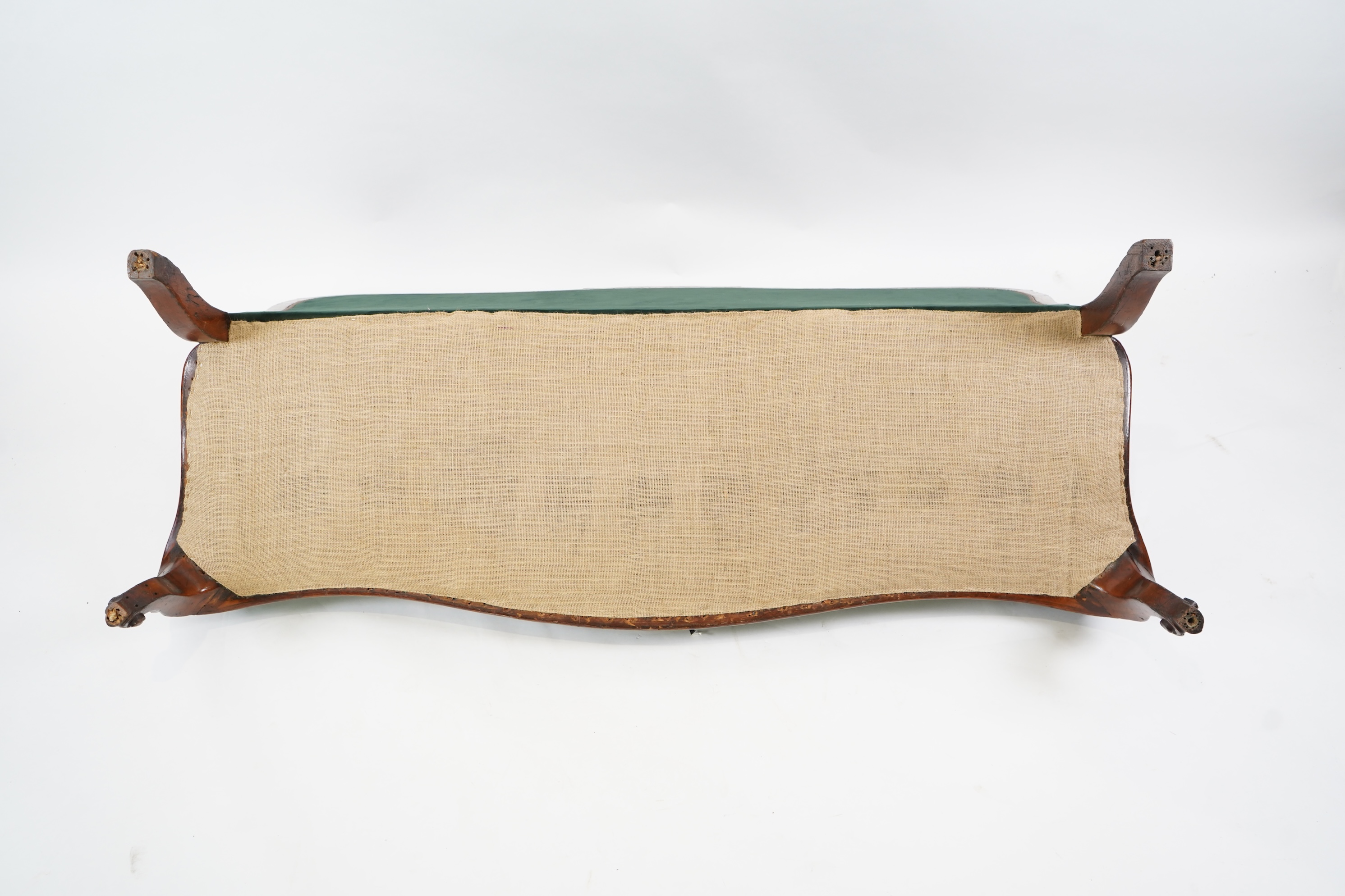 A pair of Victorian carved oak settees, recently re-upholstered in deep buttoned green velvet, the scroll carved crest rails over serpentine seats on cabriole front legs, 160cm wide, 96cm high, Provenance - previously gi